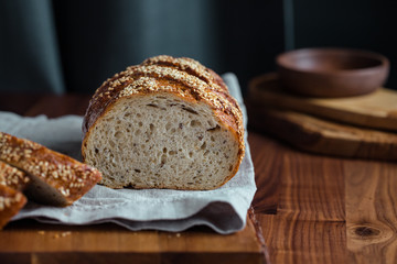 Whole grain loaf bread with chia seeds on a cutting board. Healthy eating concept.