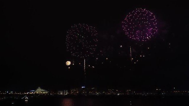 Fireworks rockets explode in the night sky on the riverbank in Riga town. Latvia celebrates a proclamation anniversary. 