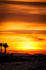 A full sun setting over the sea, reflecting in the water