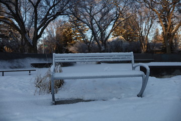 Steel ice and snow winter bench.