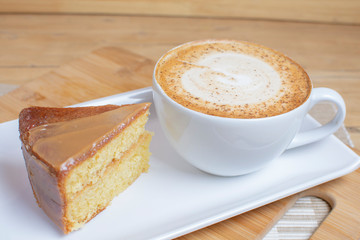 vanilla and arequipe cake accompanied by coffee with milk