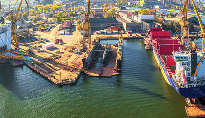 Fototapeta na wymiar Spectacular panorama submarine and ship in dry docks. Poland, Gdansk shipyard, drone footage.