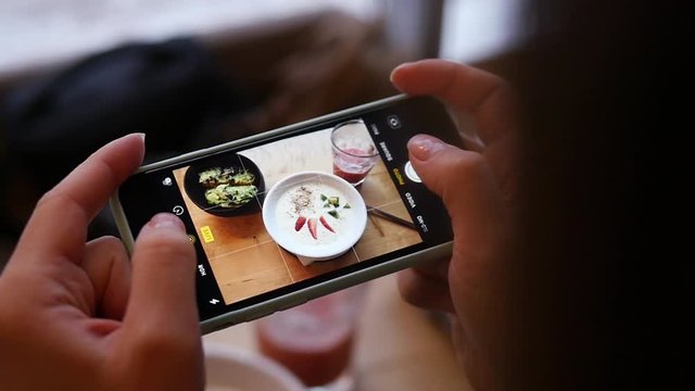 Woman Hands Taking Photos Of Dinner Food By Smartphone. Closeup.