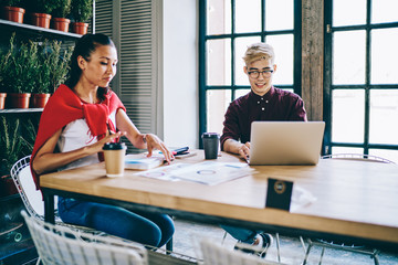 Asian male and female students preparing to university examination using 4g wireless internet on laptop computer and other equipment for making research of information, concept of collaboration