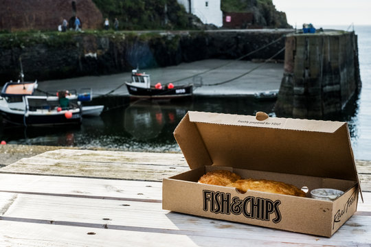 Box With Fish And Chips Placed On Table