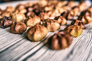 Choux pastry on a wooden background. Photographed in high key, closeup.