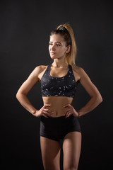 Fototapeta premium beautiful young woman with an athletic figure on a black background