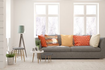 Stylish room in white color with sofa and winter landscape in window. Scandinavian interior design. 3D illustration