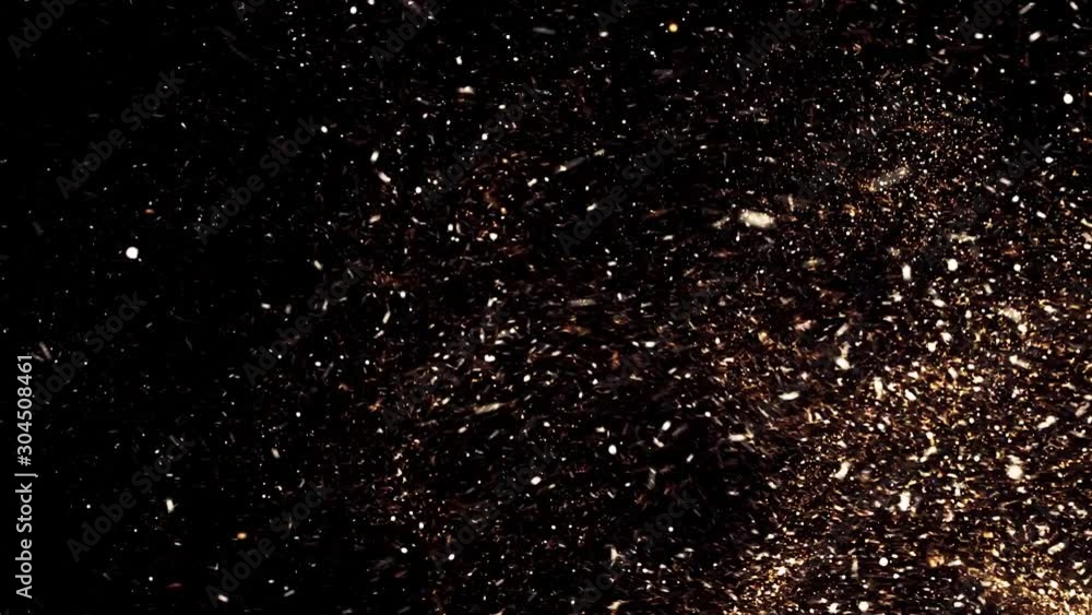 Poster beautiful golden flying dust particles with on black background. animation. fast motion of shining d