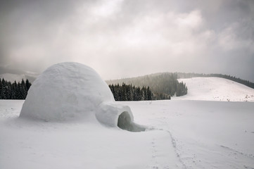 igloo in snowy winter mountains