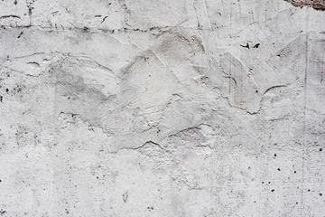 Texture of a concrete wall with cracks and scratches which can be used as a background