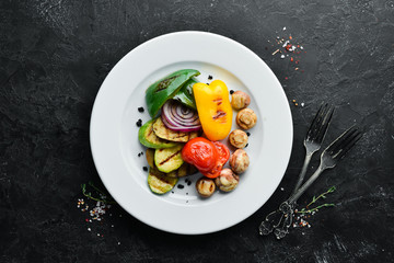 Grilled vegetables: zucchini, tomatoes, paprika, onion. Top view. Free space for your text.