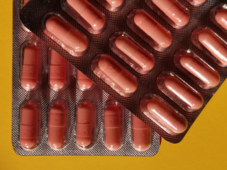 Blisters with brown tablets, pills or food additives. Abstract close-up photo on the subject of...