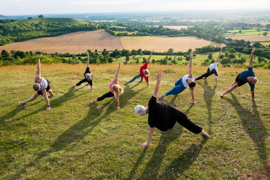 Group of people performing yoga exercises