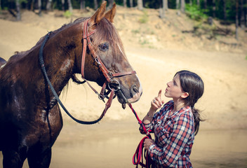 Obraz premium portrait of girl and red trakehner stallion horse in the river in the summer