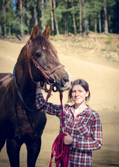 Obraz premium portrait of girl and red trakehner stallion horse in the river in the summer