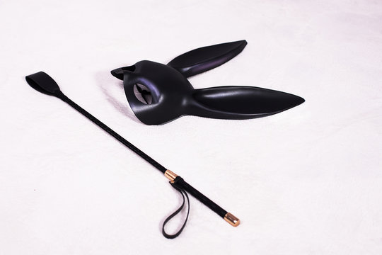 Leather Rabbit Mask And Whip On The Bed