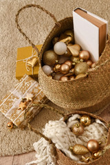 Christmas interior in white and golden shades. Baskets with different christmas decor and gifts