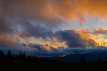 sunset mountain sky blue colorful autumn sun light yellow orange clouds tree smoke fog haze