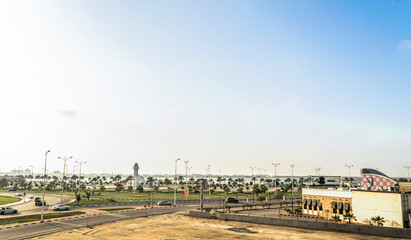 Obraz premium beautiful view of a modern clean growing city and dramatic clouds on the sky during the sunrise 