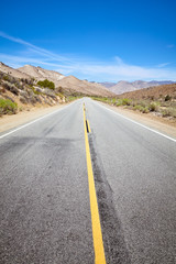 Fototapeta na wymiar Scenic road in the Death Valley, focus on asphalt, USA.