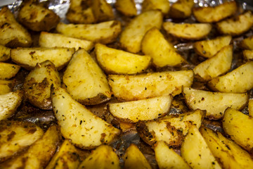 Fried potatoes in the oven.Cooking baked potato. Potatoes peasant. Potatoes with spices. Potatoes on the foil.