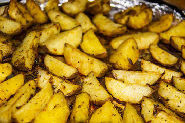 Fried potatoes in the oven.Cooking baked potato. Potatoes peasant. Potatoes with spices. Potatoes on the foil.