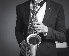 one caucasian man saxophonist playing saxophone player in studio silhouette isolated on white...