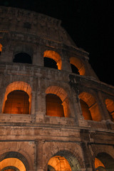 Colosseum in rome at night with illuminated arches 