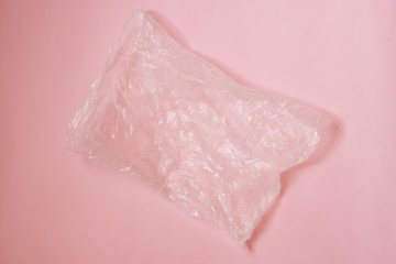 Eco concept. Cellophane transparent bag on a pink background. Place for text