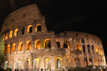 Fototapeta na wymiar Colosseum in rome at night with illuminated arches 