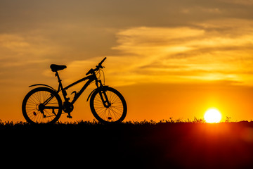 Fototapeta na wymiar Mountain bike on the hillside at sunset.