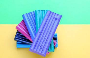 Multi-colored plasticine on a yellow and green background