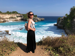 woman looks on View of the Blue Lagoon in Nusa Ceningan. turquoise lagoon beach near lembongan island