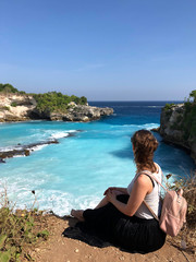 woman looks on View of the Blue Lagoon in Nusa Ceningan. turquoise lagoon beach near lembongan island