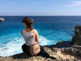 woman looks on View of the Blue Lagoon in Nusa Ceningan. turquoise lagoon beach near lembongan island