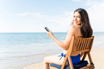 Woman With Smartphone At Beach