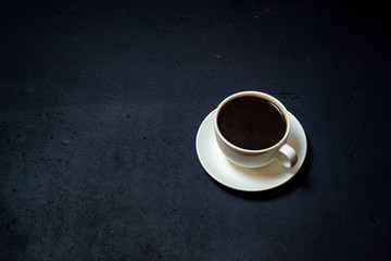 coffee in a white cup on a dark background