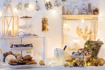 Christmas decoration cocoa bar with cookies and sweets in white and gold and vintage style