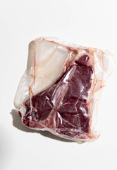 T-bone Steak Vacuum Sealed on White Background