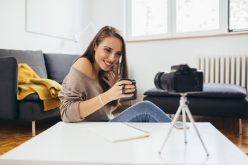 woman vlogger recording a vlog from her home