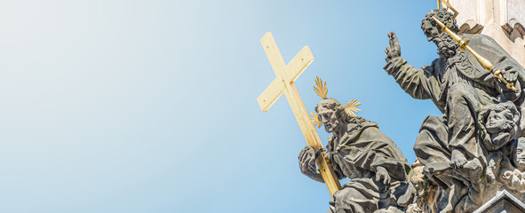 Banner with Column of the Holy Trinity and Figures of Saints holding the cross in Prague, Czech Republic