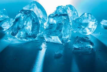 Texture of crushed ice pieces in backlight as a background