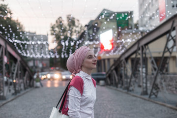 portrait of fashionable young European Muslim woman with hijab walking on the streets of Sarajevo....