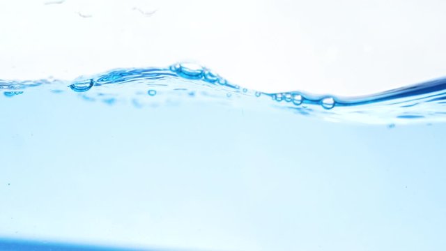 Blue water with bubbles slow motion.