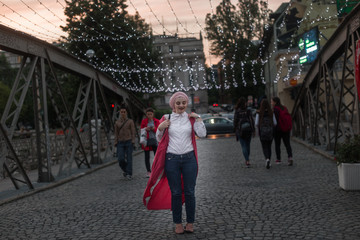 portrait of fashionable young European Muslim woman with hijab walking on the streets of Sarajevo. Image of pretty woman posing for camera. She is happy and relaxed.