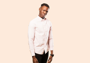 young african american black man looking happy and friendly, smiling and winking an eye at you with...