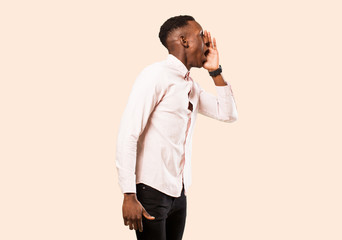young african american black man yelling loudly and angrily to copy space on the side, with hand...