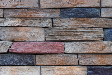 Colorful colored stone wall background close up.