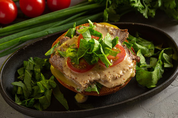 bruschetta with roast beef - baked veal tenderloin with salted cucumber, tomato, spinach and mustard sauce on a warm fried bun